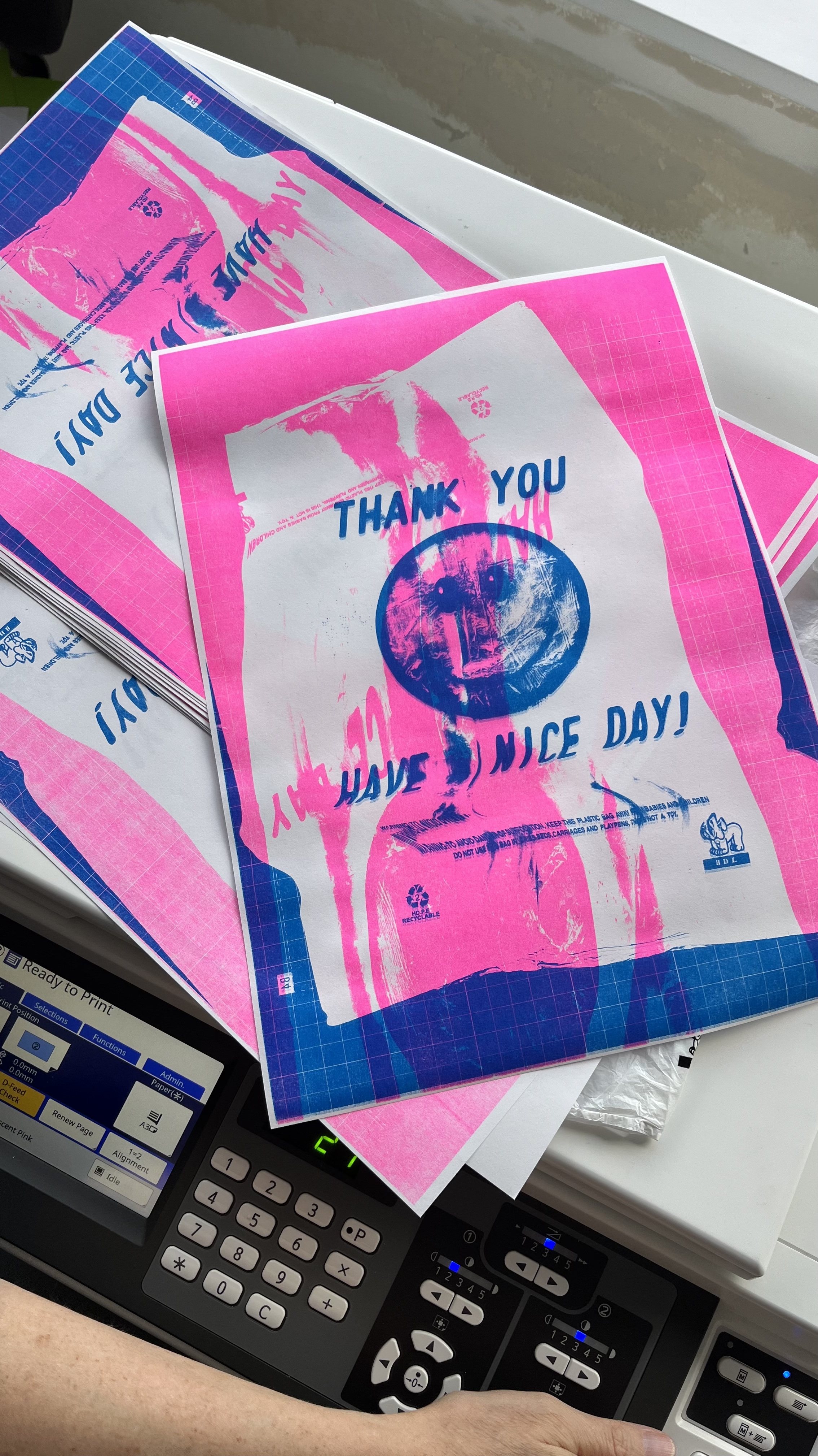 A fluorescent pink and teal risograph print of a plastic bag